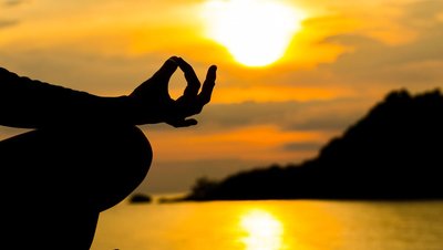 9-silhouette-hand-of-woman-meditating-in-yoga-pose-or-lotus-position-at-sunset.jpg